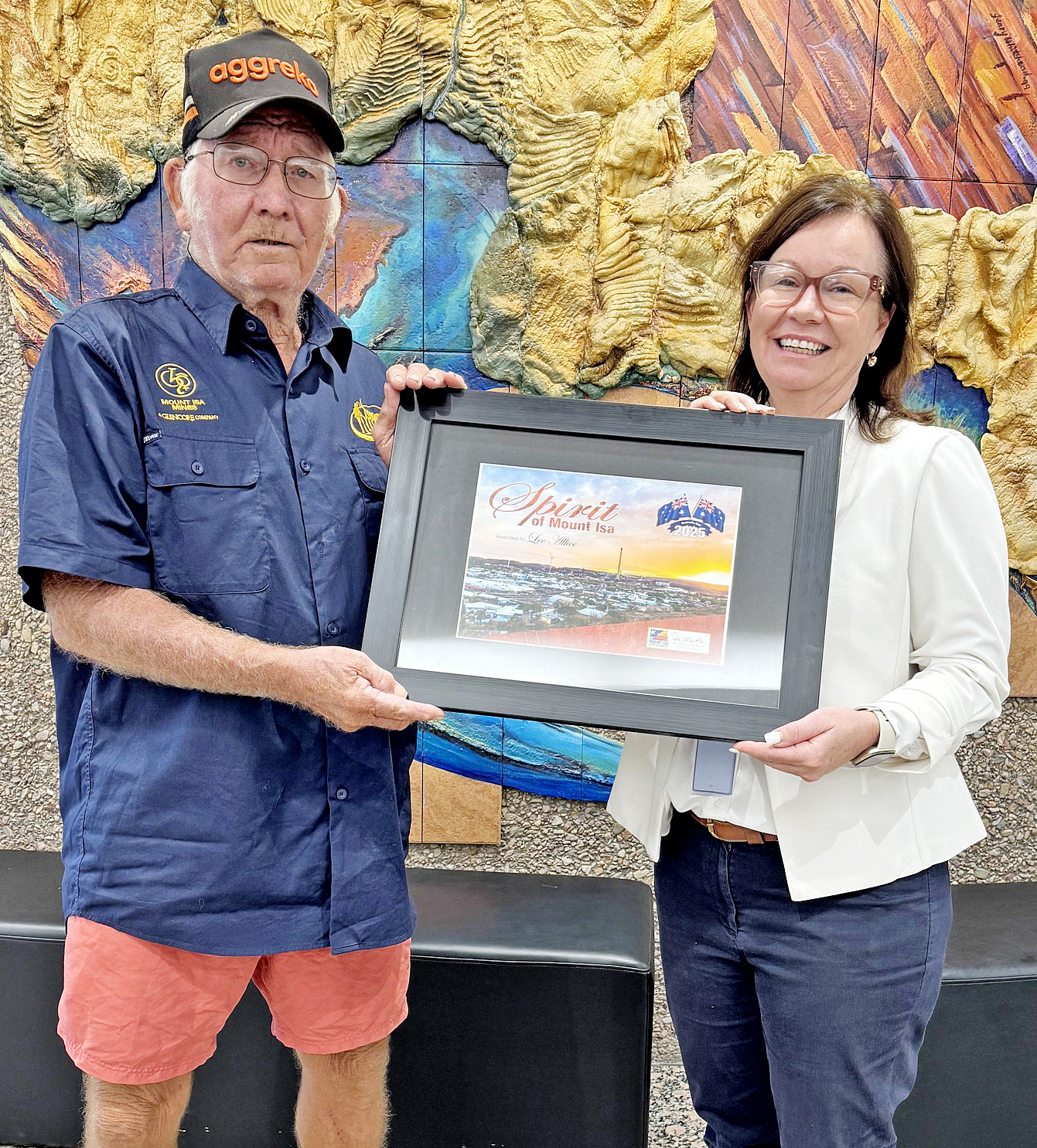 Lee Ellis collects his Spirit of Mount Isa award from mayor Peta MacRae.