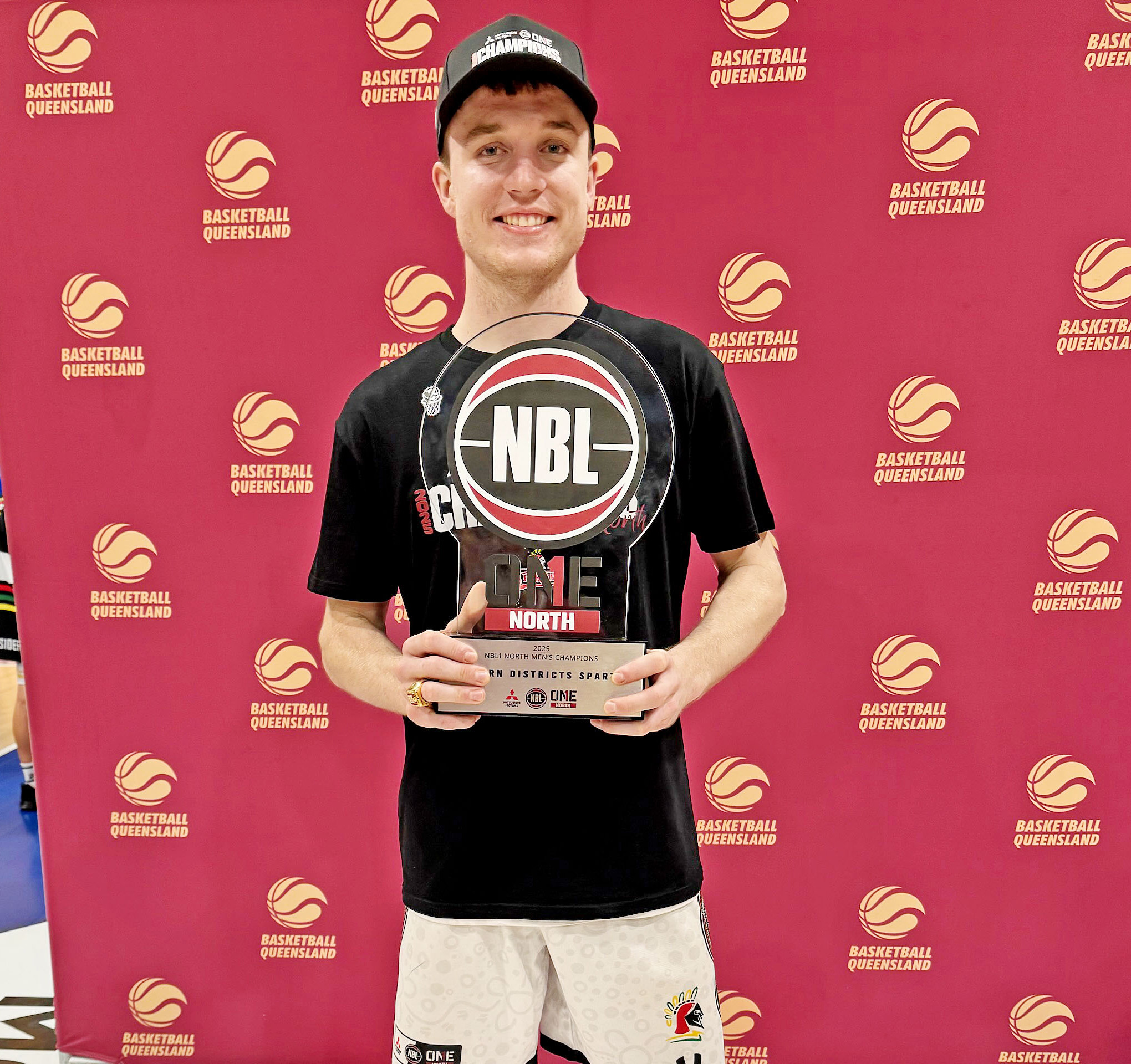 Mount Isa basketball star Darcy Ryder with the premiership trophy.