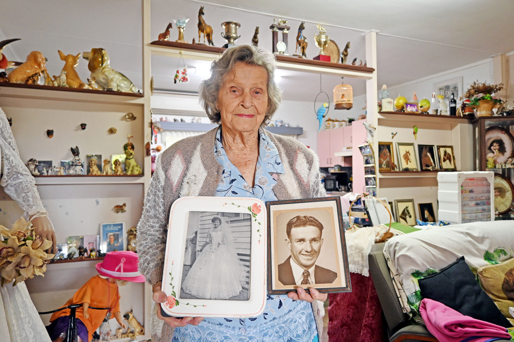 Shirley proudly shows framed photos of herself on her wedding day and her soulmate, Harry, at around the same period.