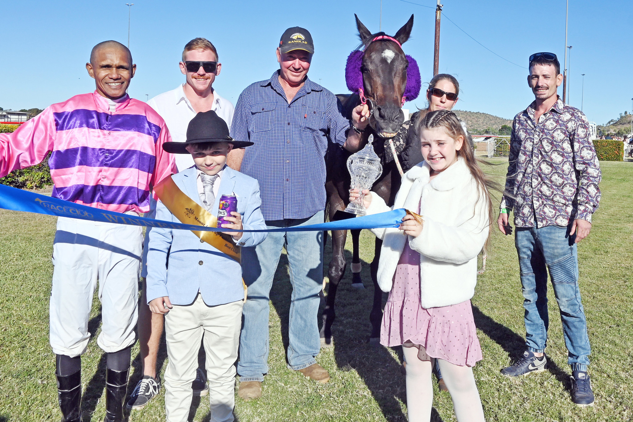 Trainer Steven Royes (cap) with winning jockey Terrence Hill and family members after Dollson claimed the Mount Isa Cup at Buchanan Park on Saturday.