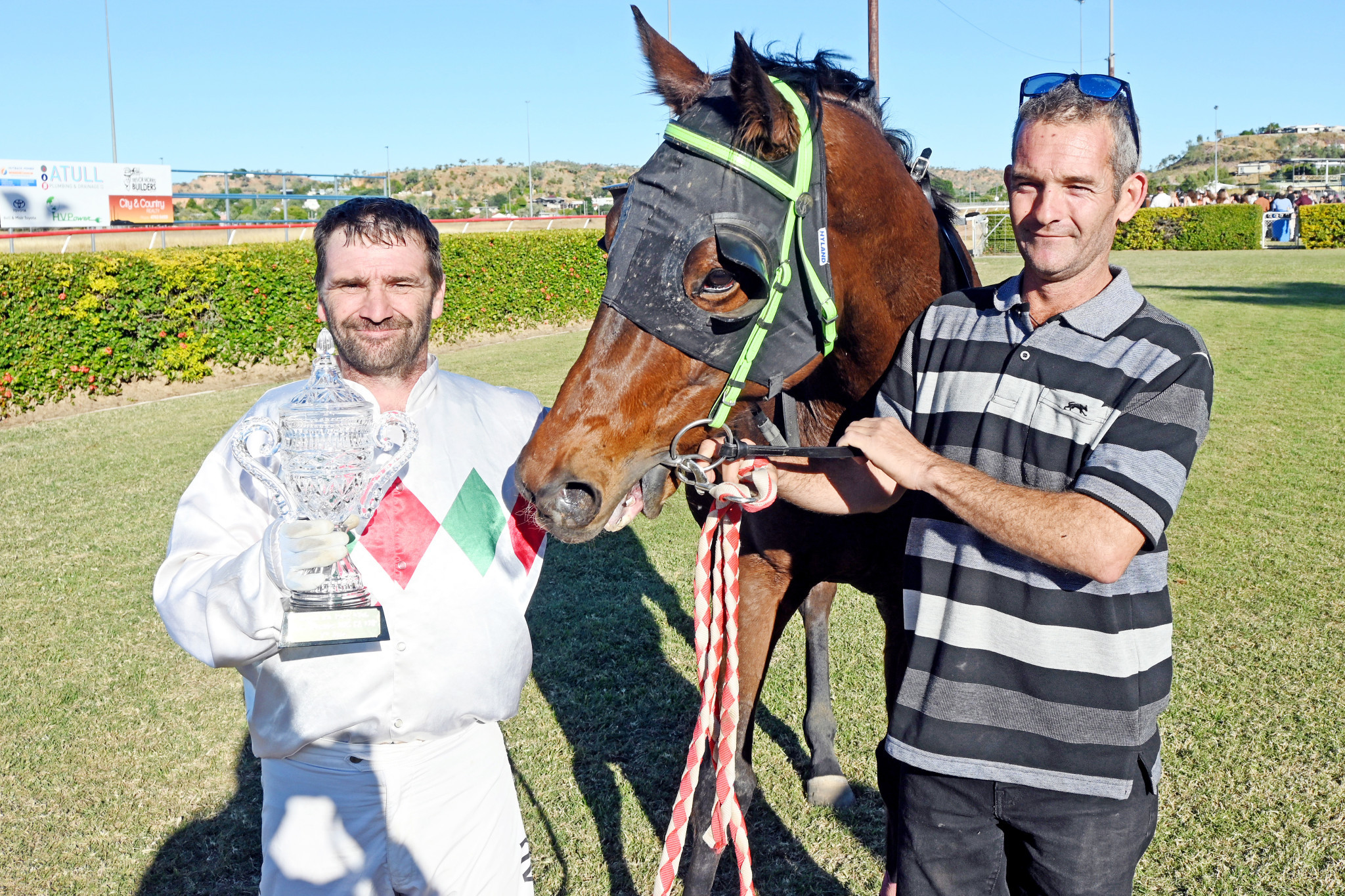 Mount Isa Cup-winning jockey Robert Faehr with strapper Jason Miller and the barnstorming Victory Bay after his 10-length romp over 1450m.