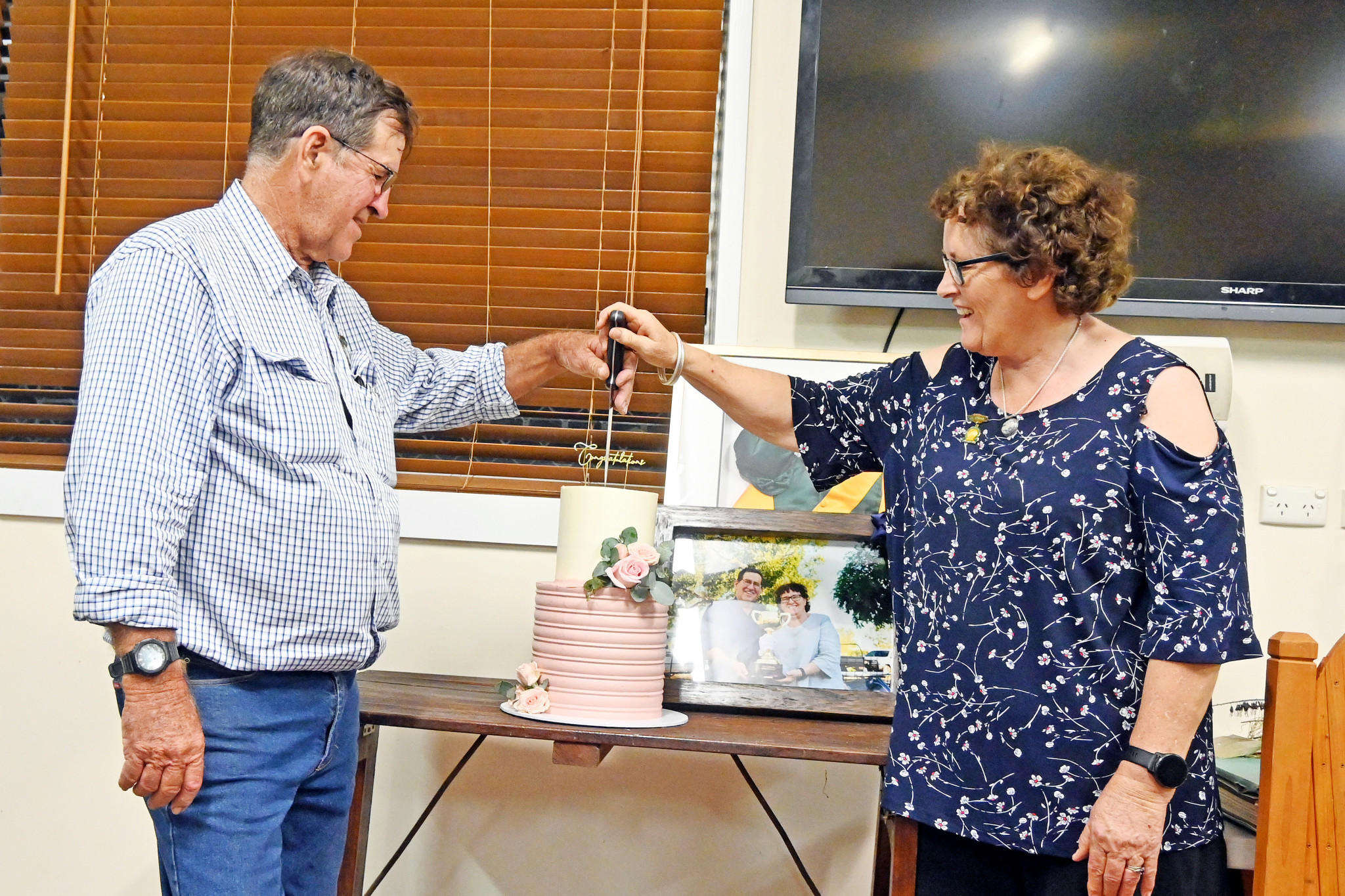 John and Sue cut a specially-made cake to mark their achievement.