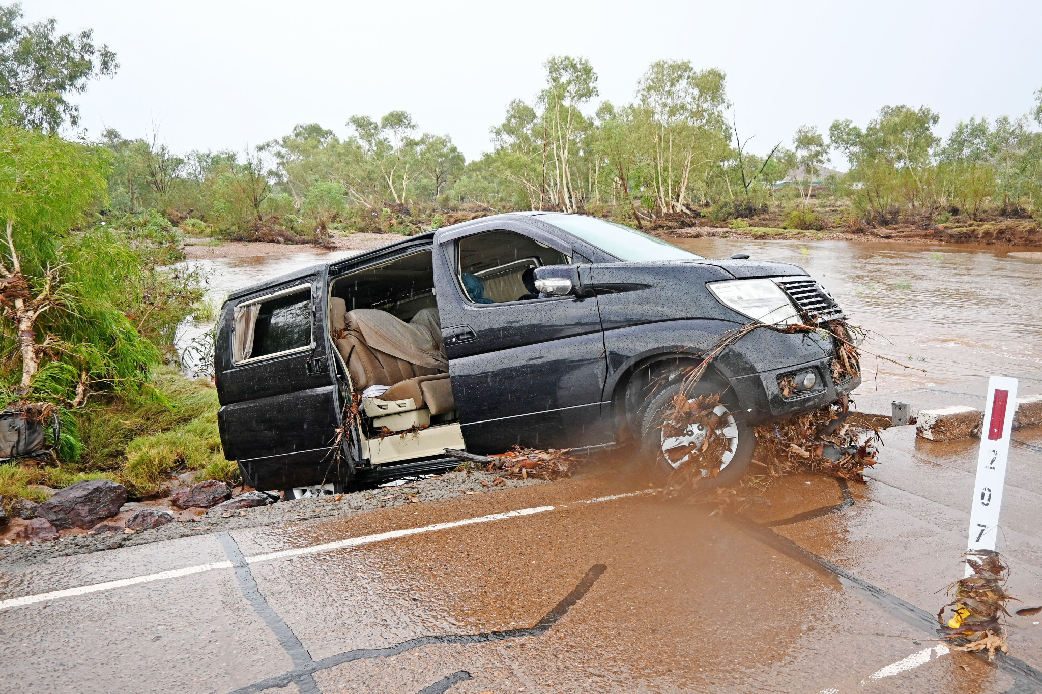 The Davis Road crossing remained closed to traffic on Friday morning as the van remained precariously perched along the roadway.