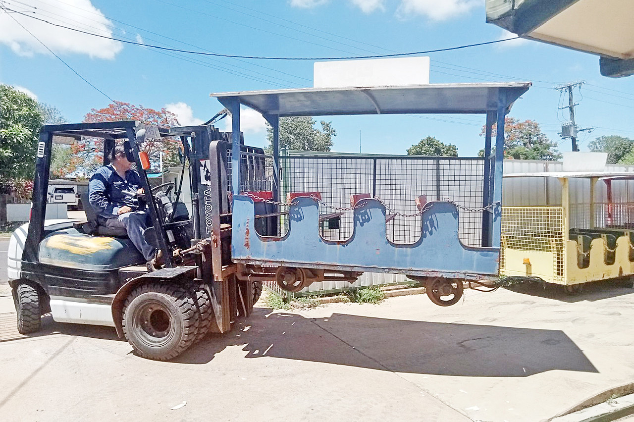 A forklift transports a train carriage into Brian’s Mount Isa home.