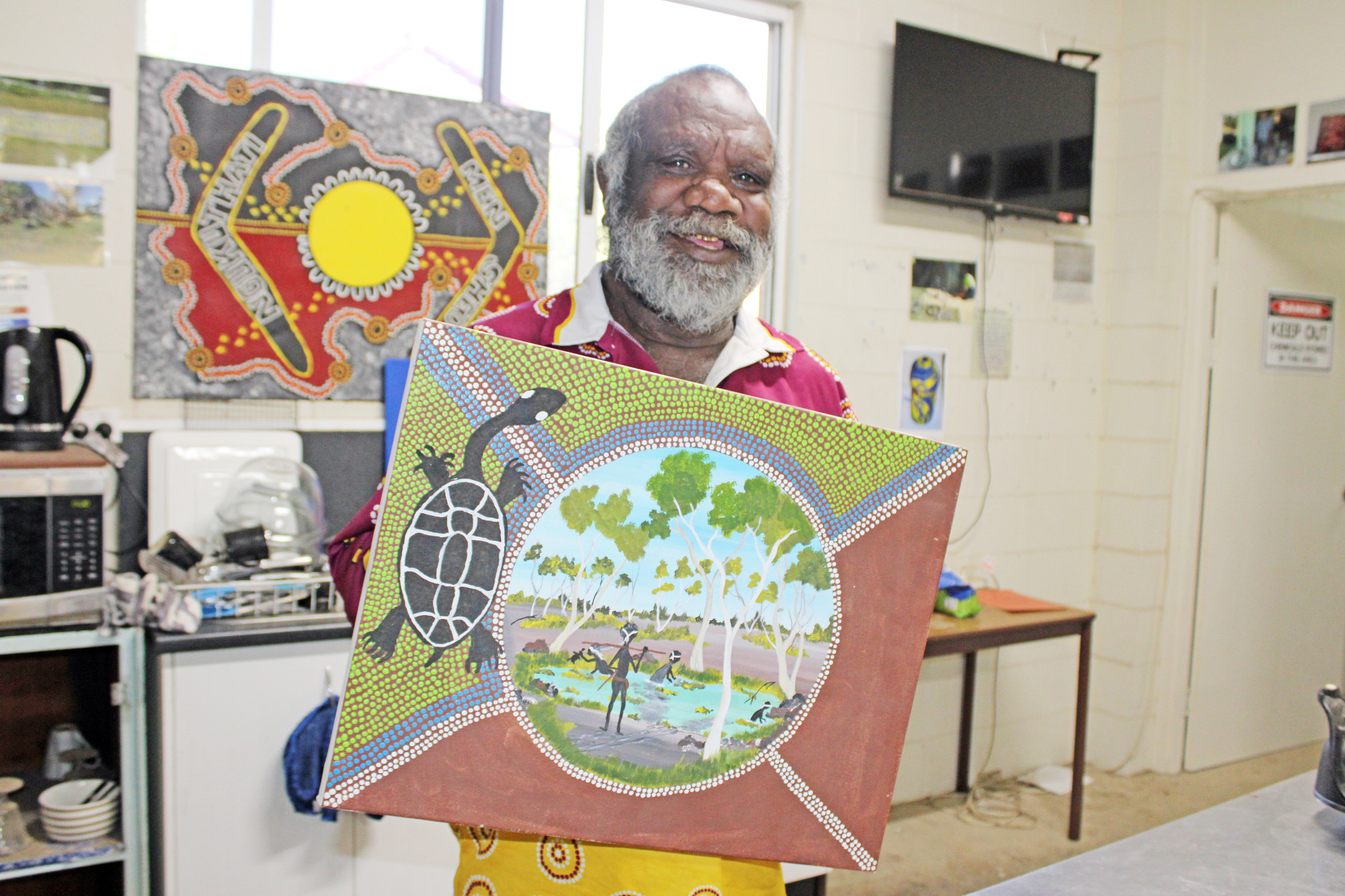 Bryan Davis-Escott displays one of the many artworks he has created at the Indigenous Men’s Shed.