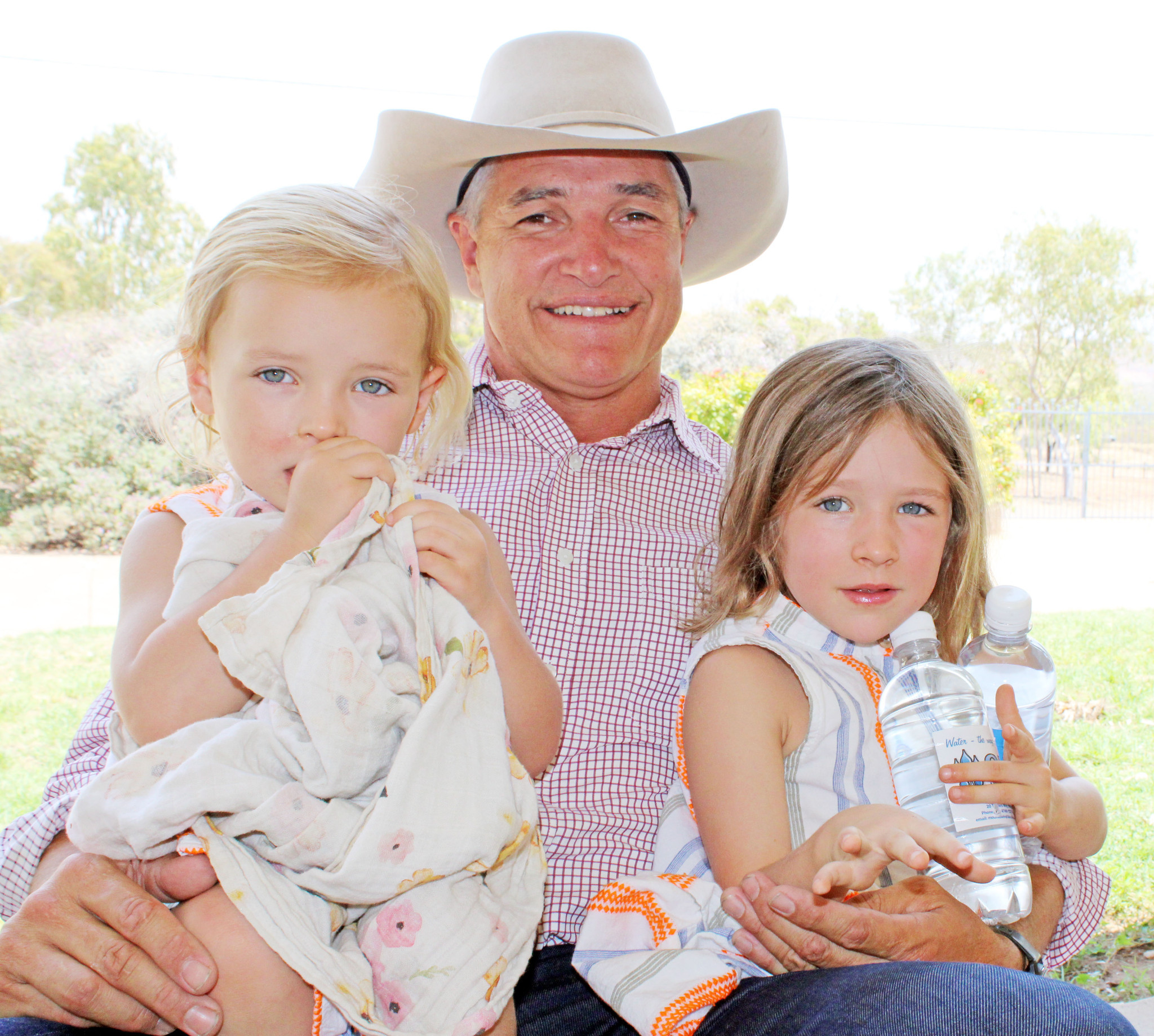 Robbie Katter spends a moment of quiet time with daughters Rosie and Peaches at home.