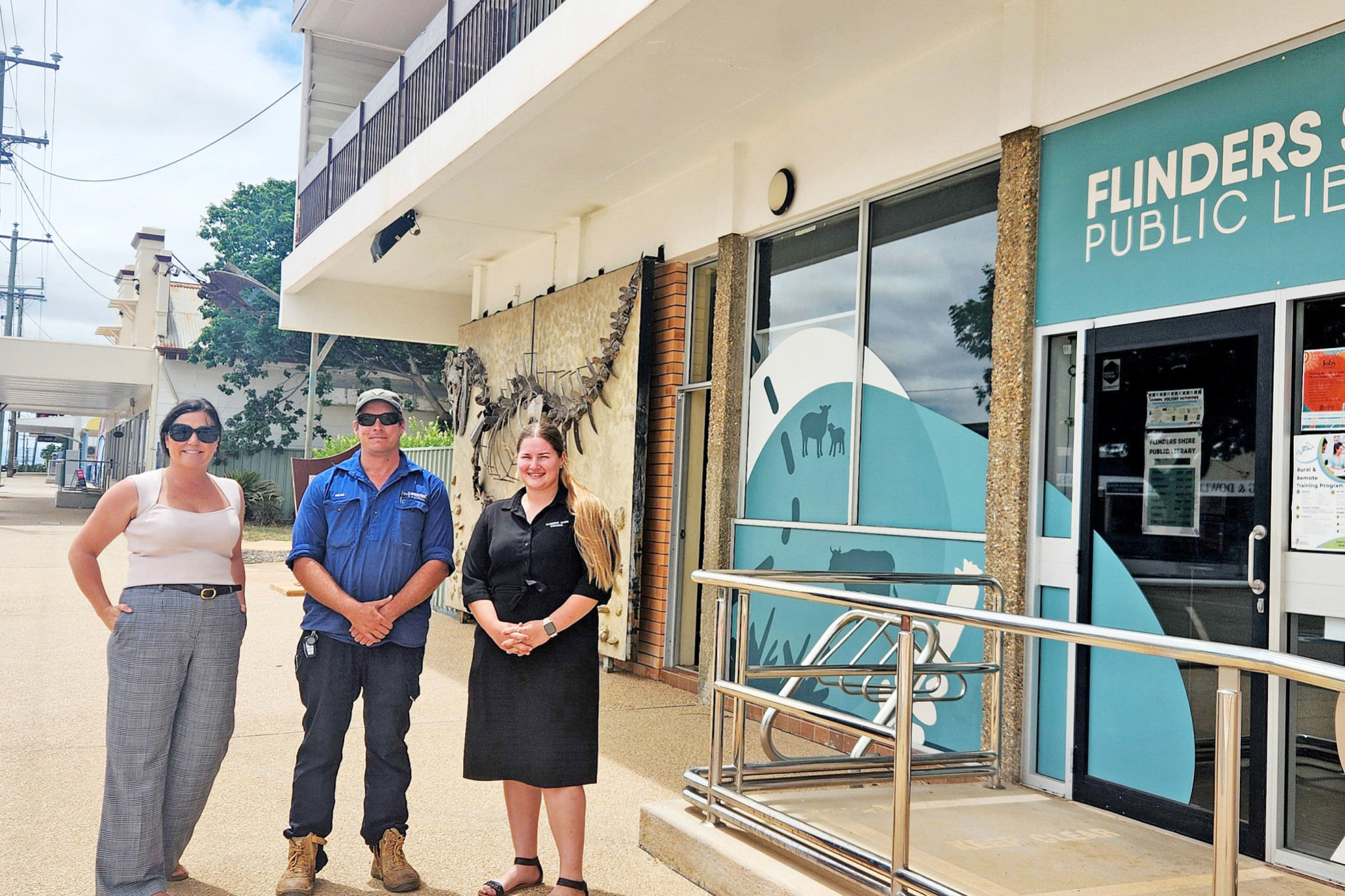 Flinders Shire mayor Kate Peddle with local tertiary students Miles Smith and Natalie Cairns outside the public library in Hughenden.