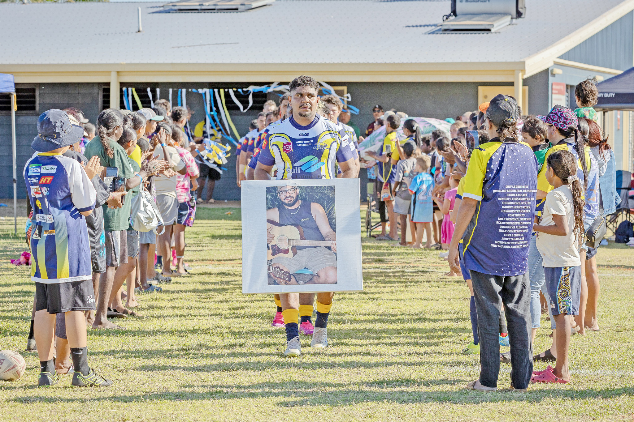 The Normanton Stingers ran out onto the ground holding pictures of lost loved ones.