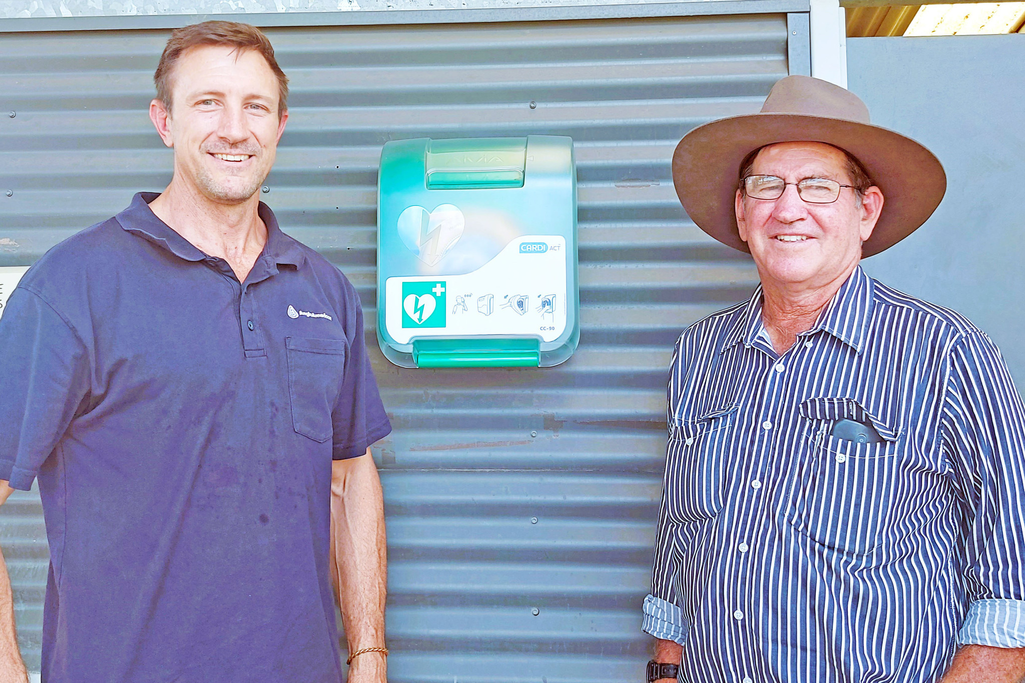 Anglo American’s Mark Jensen and Burke Shire deputy mayor John Clarke with the newly-installed Automated External Defibrillator (AED) in Gregory.