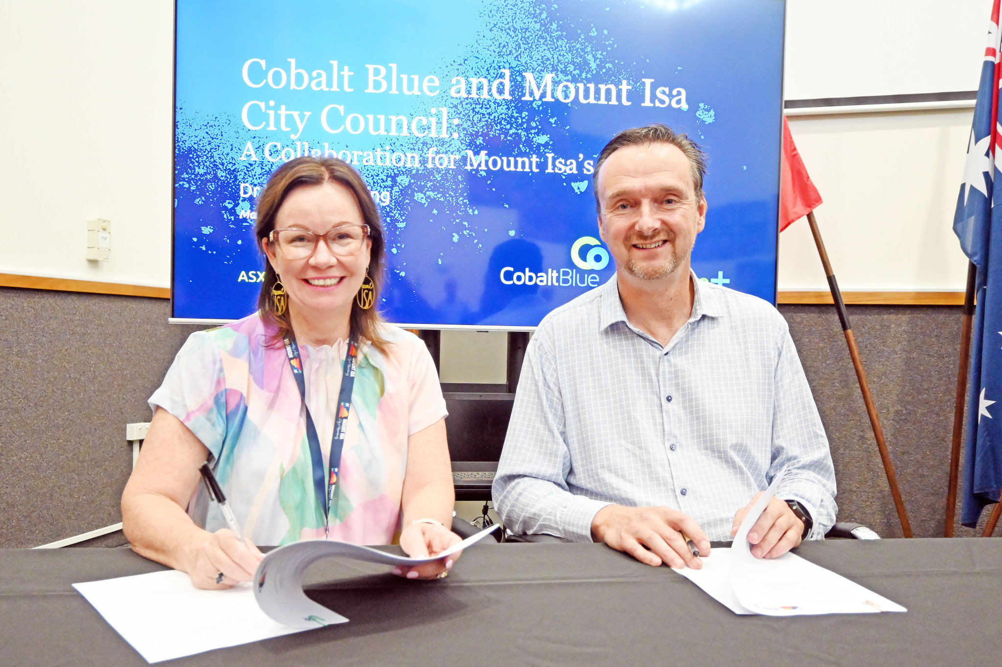 Mount Isa City mayor Peta MacRae signs the memorandum of understanding with Cobalt Blue CEO Joe Kaderavek.