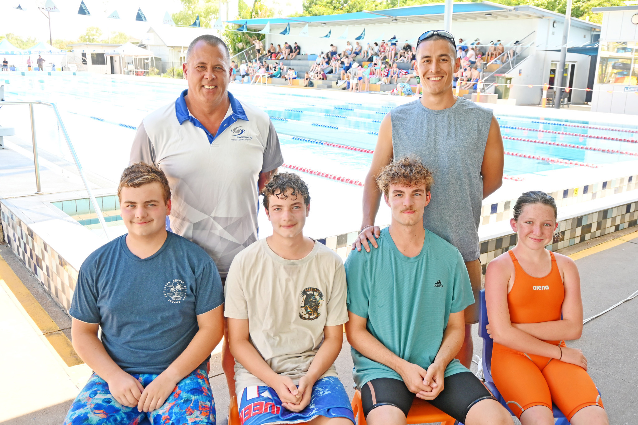 Swimming NQ development coach Chris Hanson and Mount Isa coach Mitch McDonnell with Queensland Sprint Championship competitors Connori, Trent and Luca Baccari, and Jayde Scott.