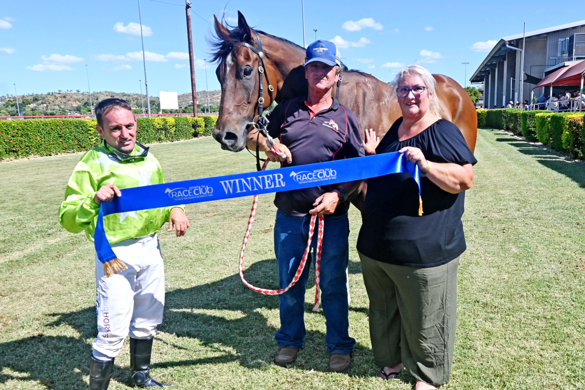 Jockey Matthew Gray with Han Dynasty and Johnson Racing representative Dale McFarlane-Ward after the running of the Kenlach Transport Open Plate (1000m) at Mount Isa on Saturday.