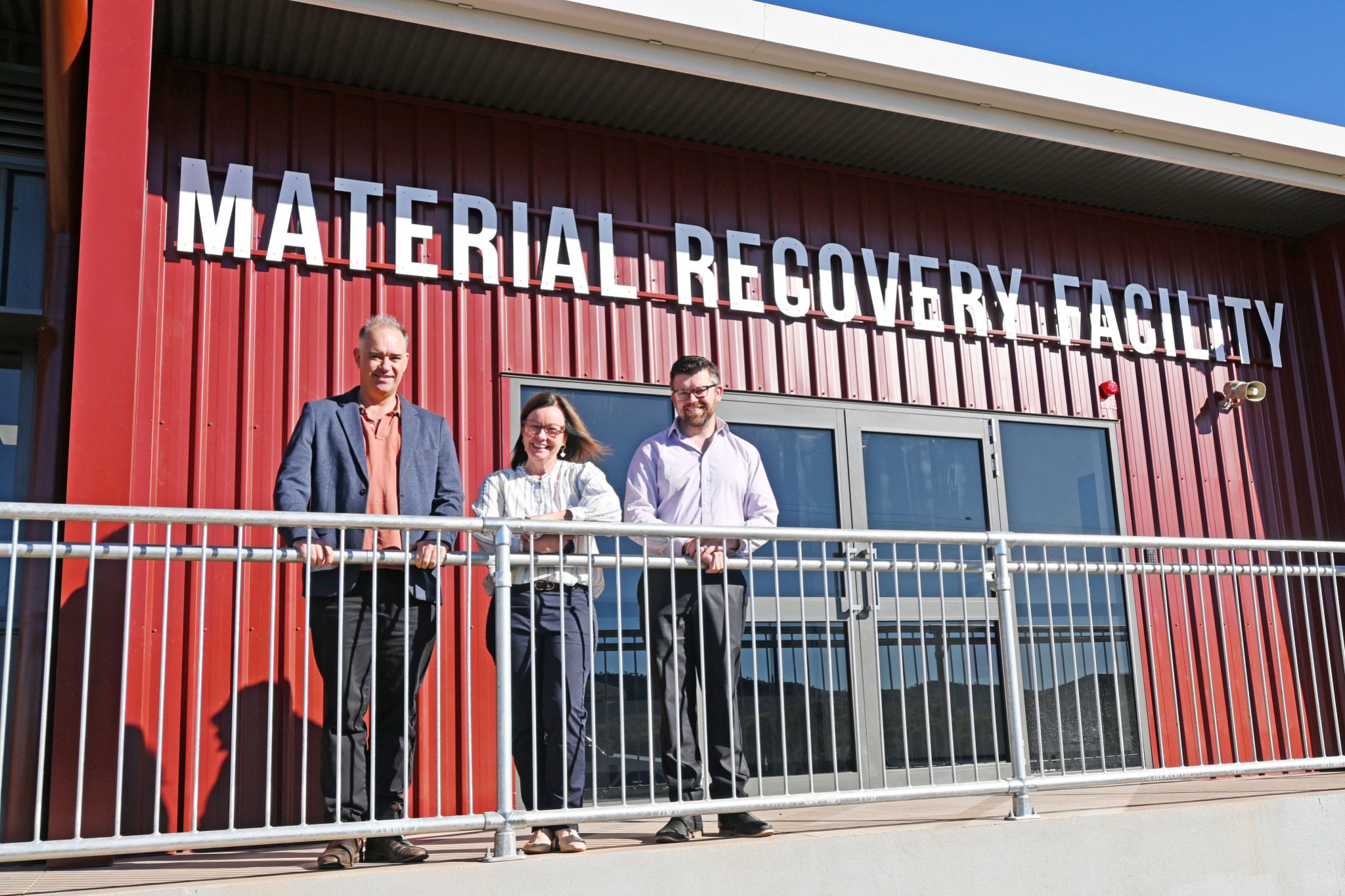 Mount Isa City Council CEO Tim Rose, mayor Peta MacRae and community services director Chad King outside the new material recovery facility that will soon be full of equipment used for sorting recyclable goods.