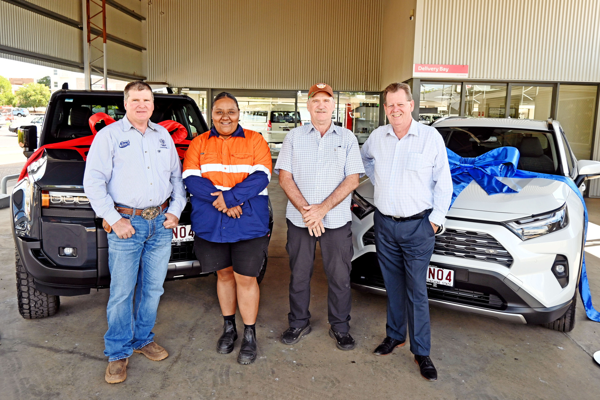 Mount Isa Pro Rodeo chair Mark ‘Tommo’ Thompson with new car winners Olivia Riggs and David Bale and Bell and Moir Toyota principal Lee Pulman, the sponsor of the annual Art Union Prize Draw.