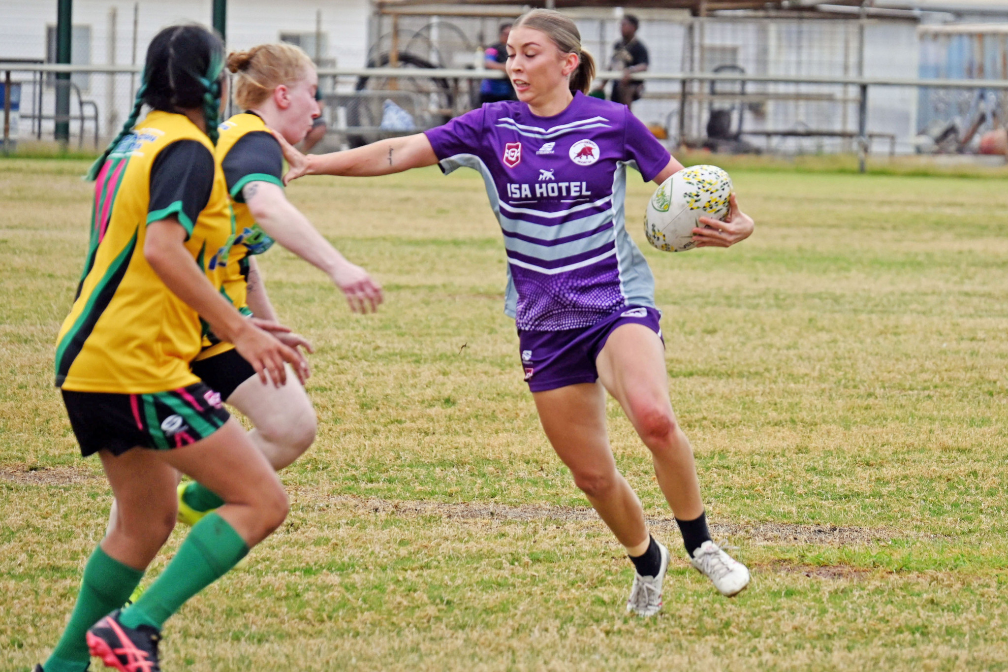 Gabrielle Holder fends off at Cloncurry opponent at Alec Inch Oval.