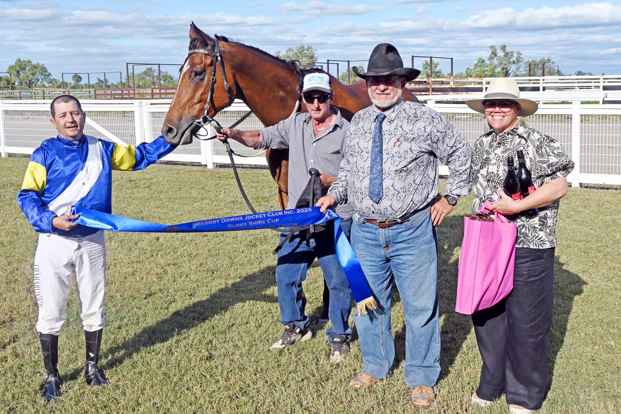 Jockey Jason Babarovich, stable foreman Justin Esser, Burke Shire mayor Ernie Camp and Gregory Downs Jockey Club secretary Bec Dixon after Mr Metrics set a new track record to win the Burke Shire Cup on Saturday.