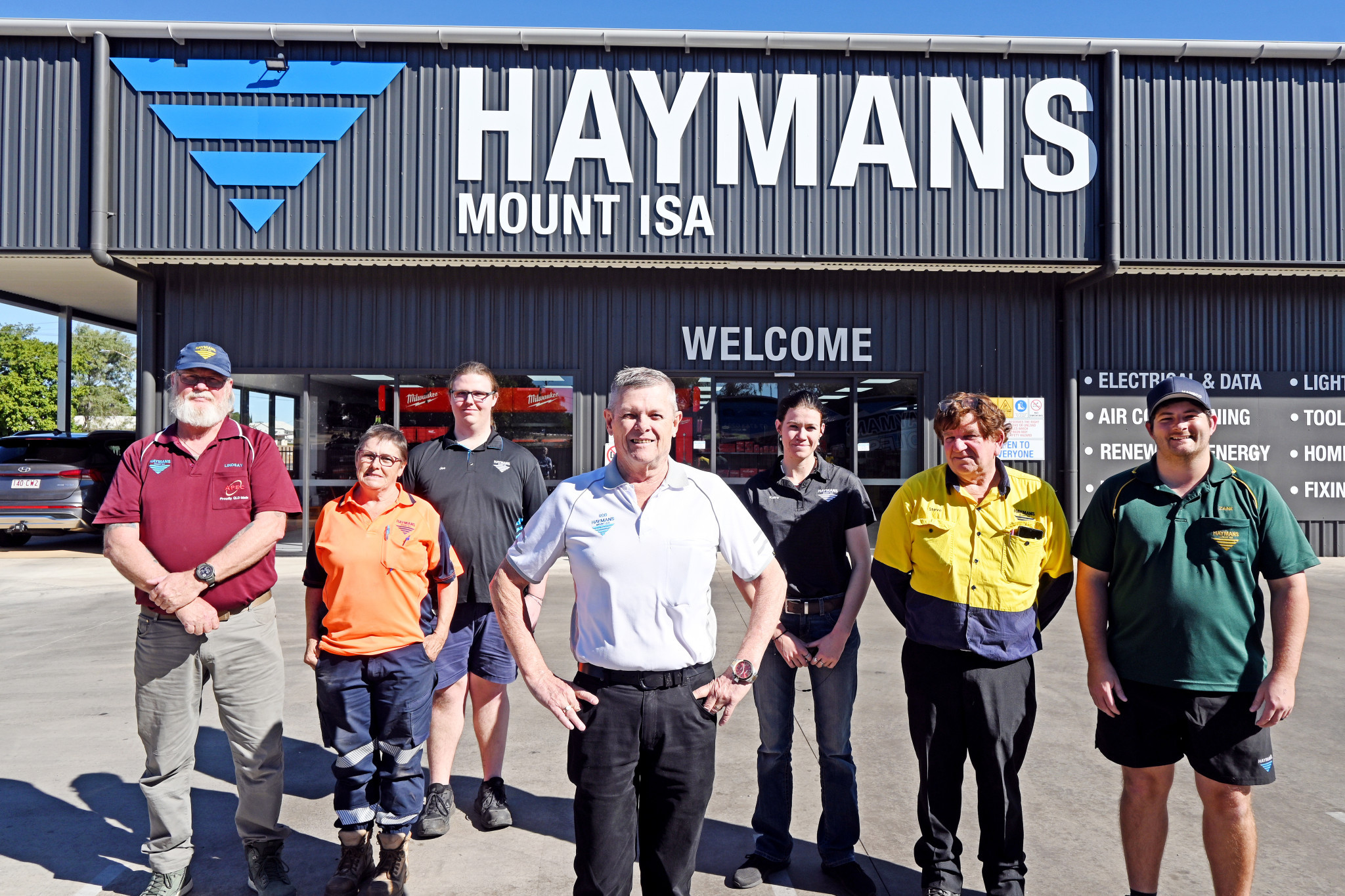 Haymans Mount Isa manager Rob Schroeter (centre) with some of the members of his 11-person team in front of their new locally-built headquarters on the corner of West and Alma Streets.