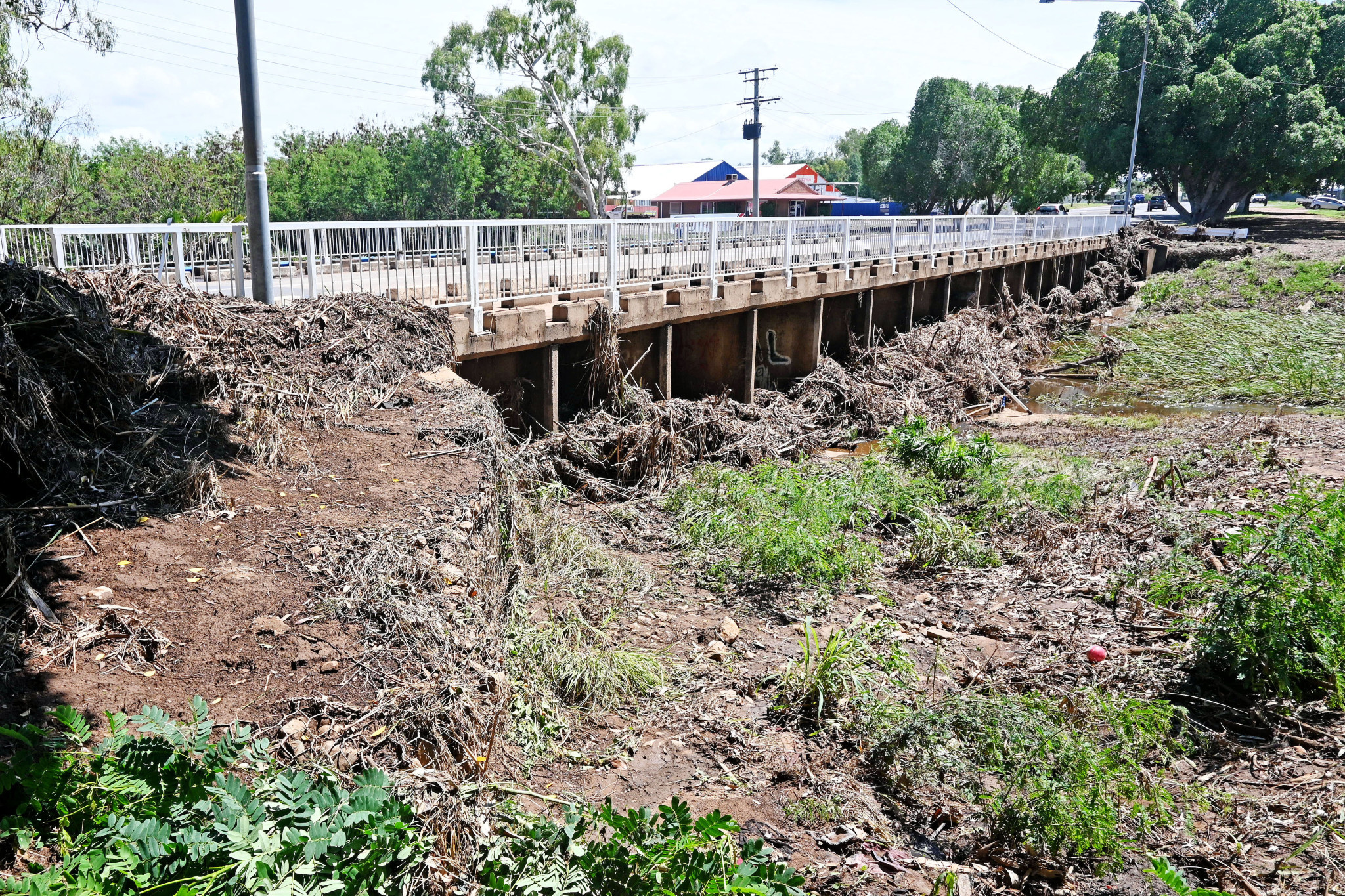 Debris lines the bridge over Breakaway Creek in Sunset after a flash flood hit the suburb late last month.