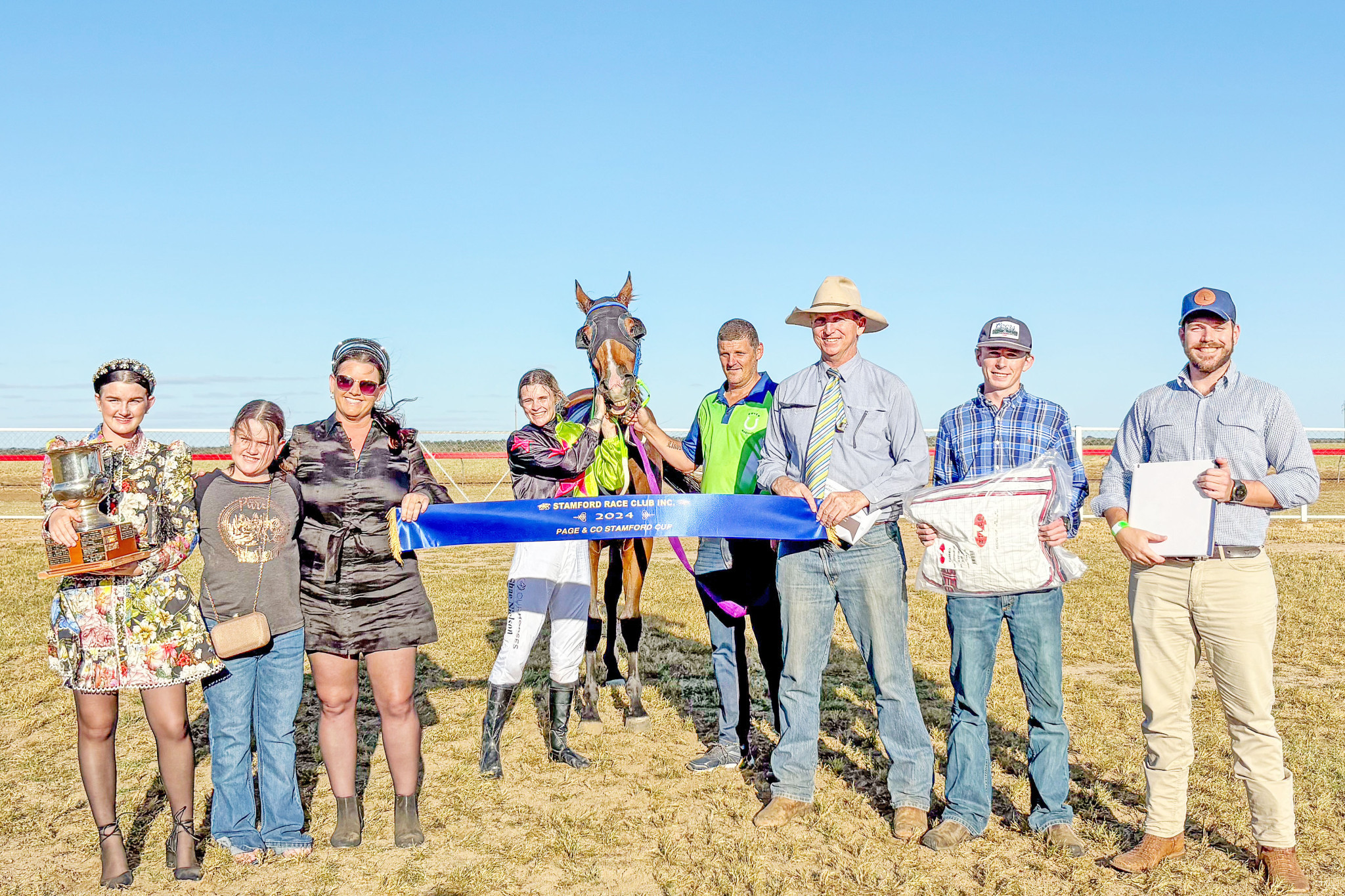 Trainer Nathan Coves and jockey Shae Nielson with sponsors and members of the Stamford Race Club at Hughenden on Saturday.