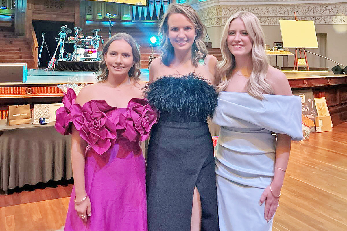 Amy Kuhne with Charlotte Hood and Bella Hanson at the Brisbane City Hall on Saturday night.