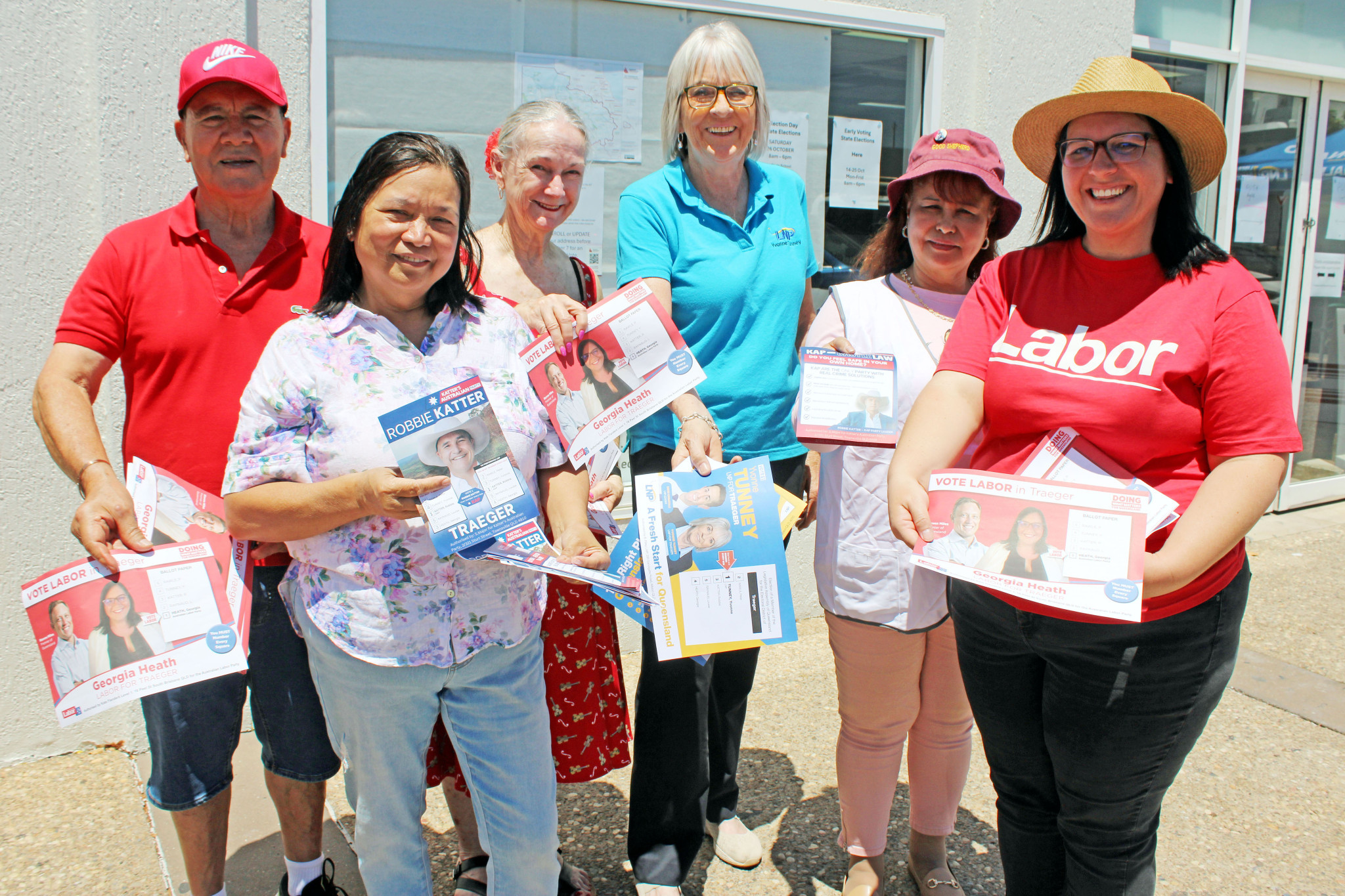 Political party volunteers at the Mount Isa early voting centre this week, including LNP candidate Yvonne Tunney (centre in blue) and Labor candidate Georgia Heath (right). Despite the heat and sun, they were all in good spirits in the first week of voting.