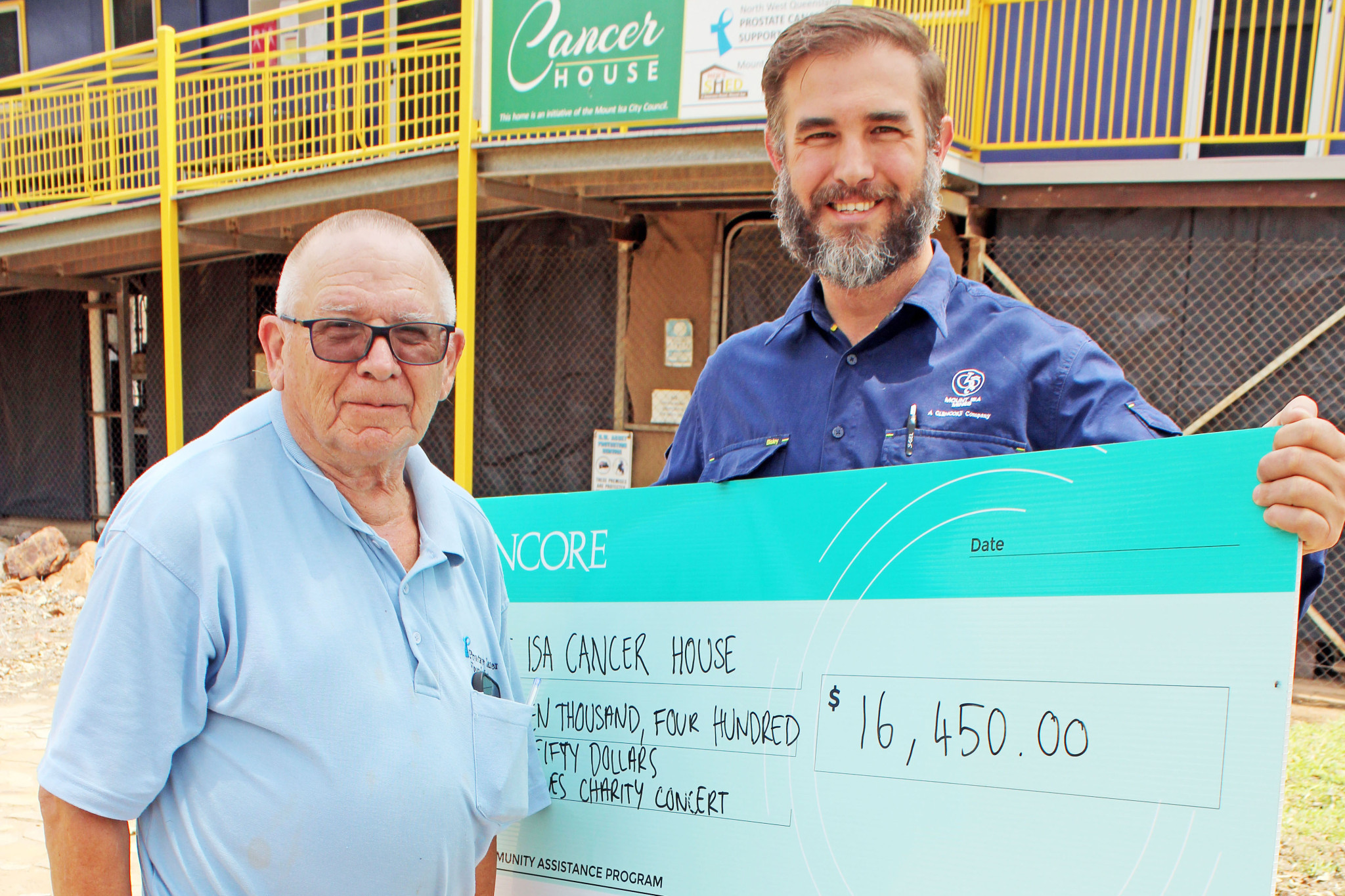 Glencore Health Safety Environment and Community manager Jonathan Eden presents the donation to Cancer House president Paul Wragg.