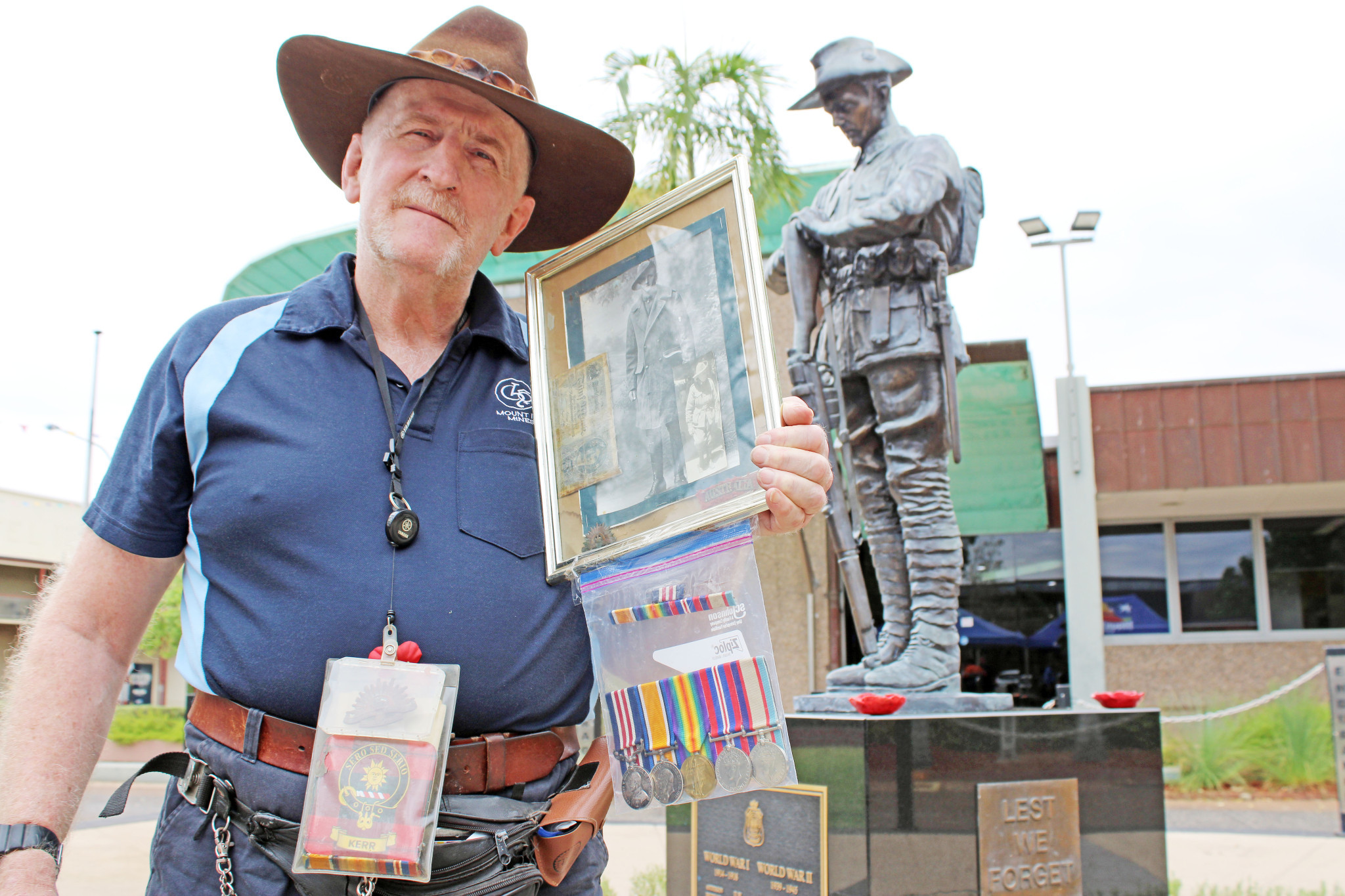 Ian Kerr with the images and medals of his veteran grandfathers.