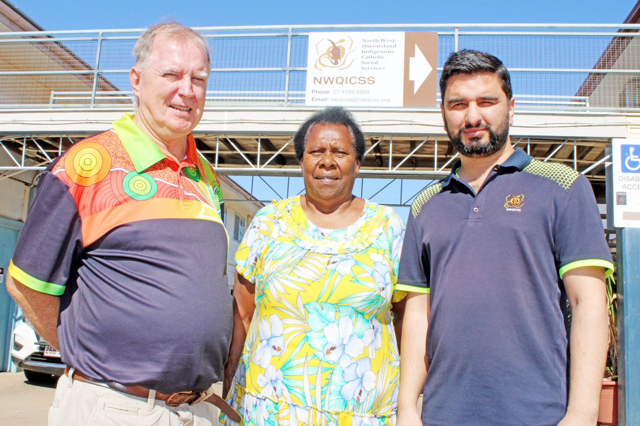 Father Mick Lowcock with Church Elder Aunty Dolly Hankin and North West Queensland Indigenous Community Social Services chief executive officer Faisal Khan.