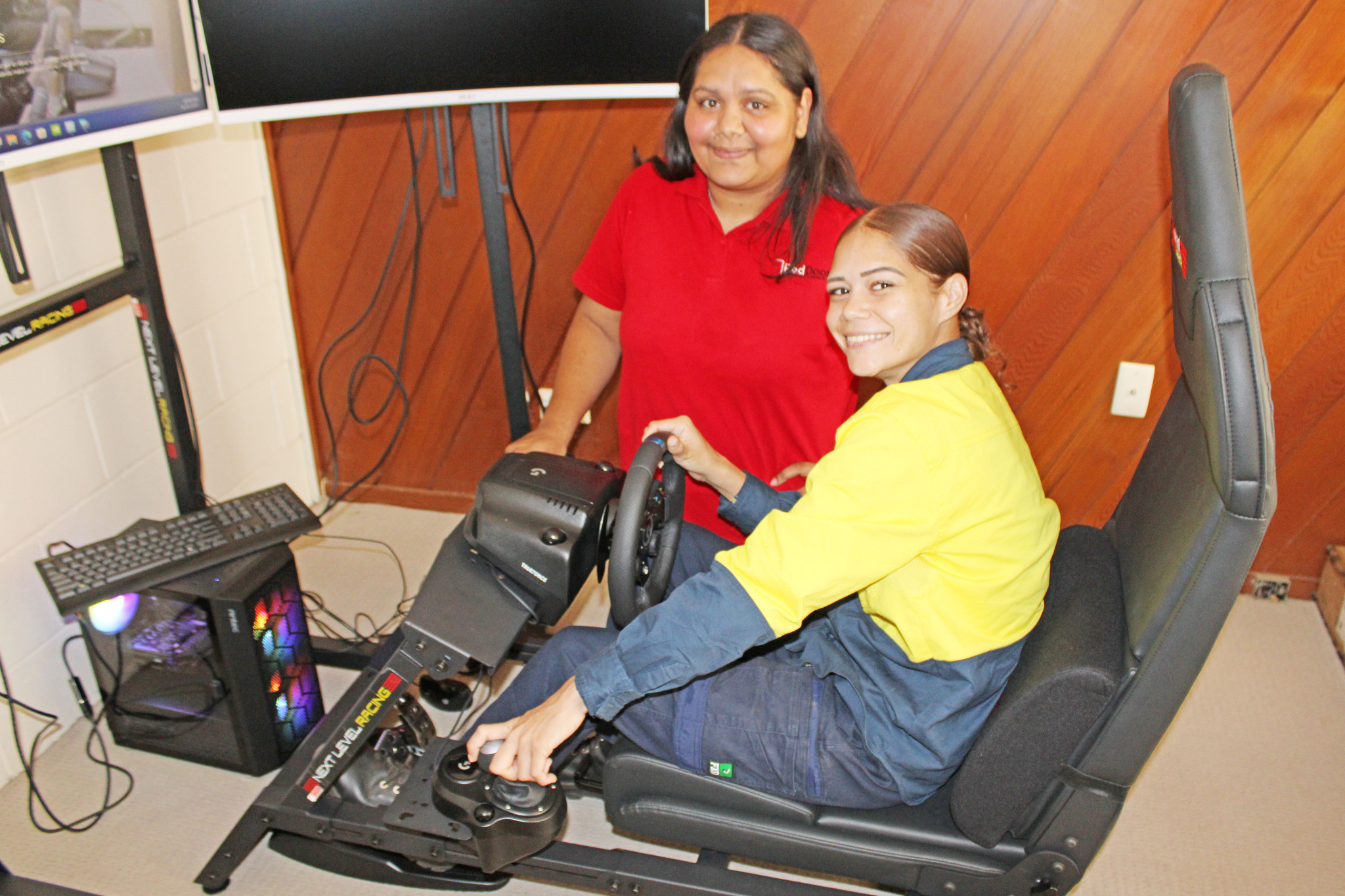 Loggin Leaner Driving program coordinator Lladyssa Douglas shows Kashantai Doyle the new driving simulator on offer in Mount Isa and Cloncurry.