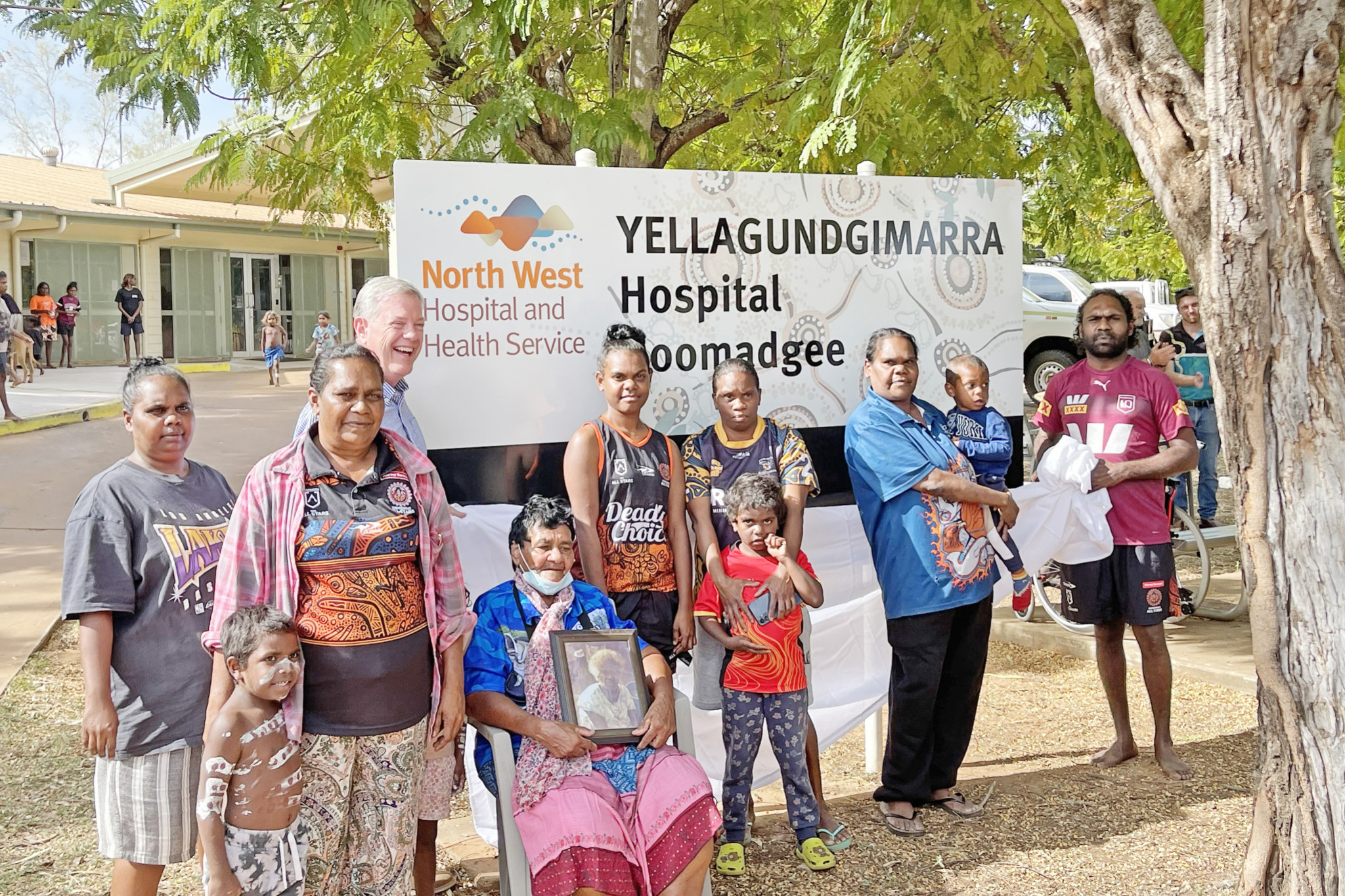 The new Yellagundgimarra Hospital Doomadgee sign was recently unveiled at a community event with Queensland Minister for Health and Ambulance Services Tim Nicholls alongside granddaughters of Yellagundgimarra – Beverley Doomadgee (seated) and Etta Diamond (third from left).